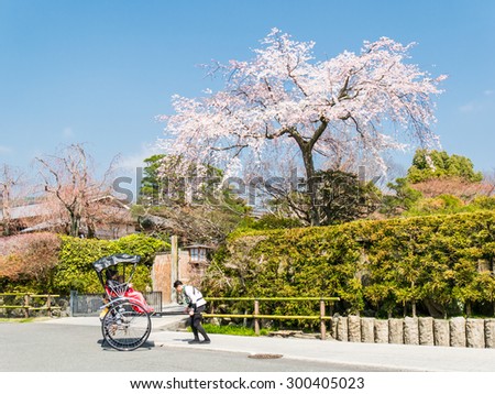 ARASHIYAMA, JAPAN - MARCH 29: Tourist ride rickshaw service on March 29, 2015 in Arashiyama, Japan. It is a district on the western outskirts of Kyoto.