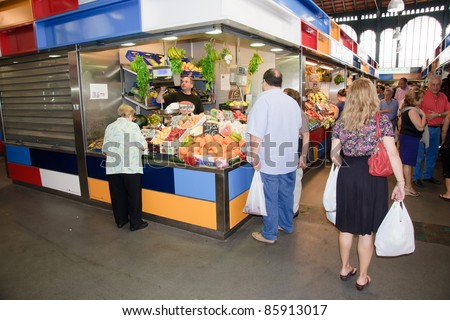 MALAGA, SPAIN - JUNE 10: Unidentified sellers pack fruits at their shop in the popular central market on June 10, 2011 in Malaga, Spain.  It was renovated in 2010 and it was reopened on March 2011.