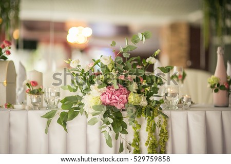 Original decoration of flowers and herbs for wedding table