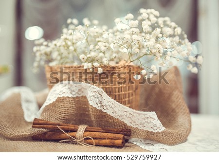 Wedding decor of cinnamon and basket with flowers gypsophila
