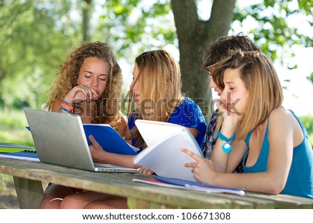 Group of young student using laptop outdoor,Italy