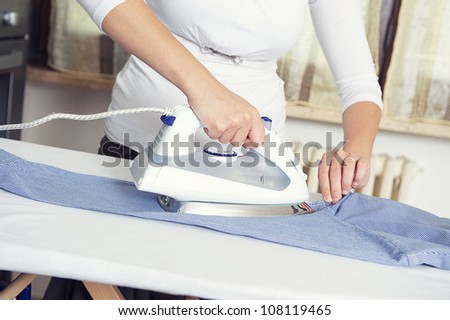 bright picture of lovely housewife with iron , Italy