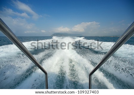 Boat wake prop wash on blue ocean sea in sunny day Italy