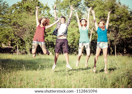 Group of Teenagers Jumping at Park,Italy