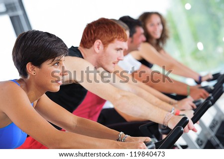 Group of five people in the gym, exercising their legs doing cardio training,Italy