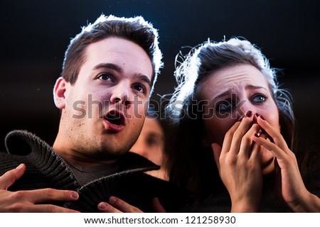 Couple scared at the cinema, watching horror movie,Italy