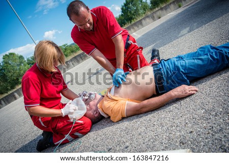 Paramedics Succor A Man With Heart Attack - Stock Image