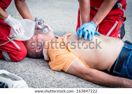Paramedics succor a man with heart attack - Stock Image