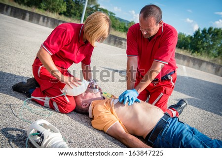 Paramedics succor a man with heart attack - Stock Image