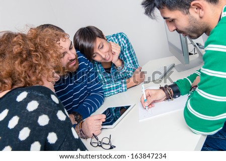 Happy Group Of Young Students Studying Together In Library - Stock Image