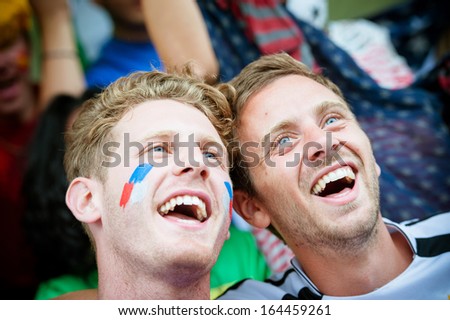 Fans of different nations at the stadium together - Stock Image