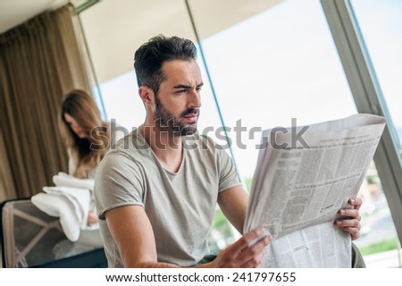 Man Reading Newspaper on Vacation