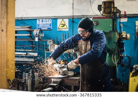 heavy industry manual worker with grinder