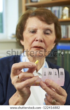 Elderly woman holing medication infront of her