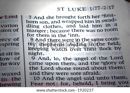 Saint Luke\'s account in the bible of the birth of Jesus Christ. A beam of light highlights the verses.