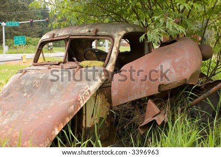 Abandoned truck in field near highway