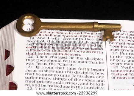 Skeleton key on bible open to reference about Keys of the kingdom.