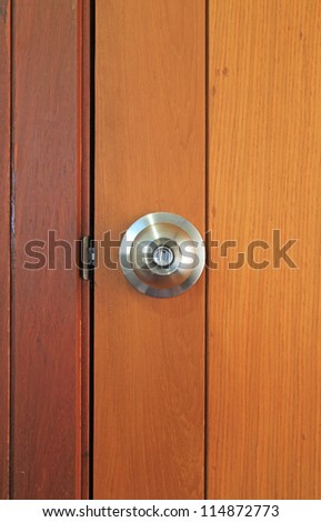 Stainless steel door knob on wooden door
