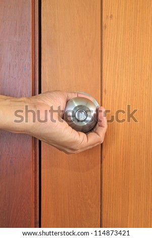 Hand opening the door