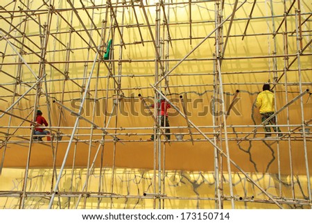Workers working during renovation of big buddha statue at Wat Muang, Thailand.