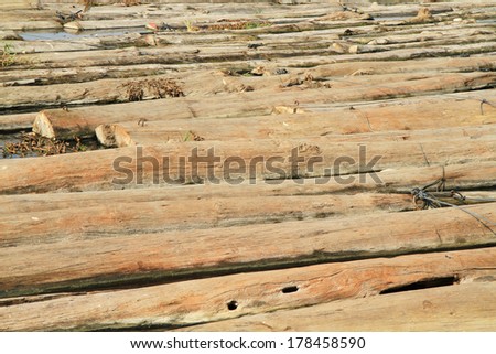 Log and lumber floating on the water