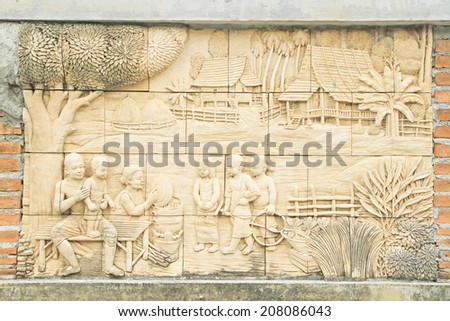 BANGKOK ,THAILAND - JUL 26 : Stone carving of Traditional Thai culture on temple wall at Wat Dan on July 26, 2014 in Bangkok, Thailand.