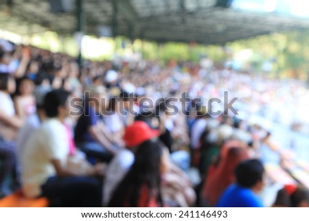 A blurred Asian crowd in a stadium