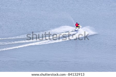 The person goes on the water scooter on the sea