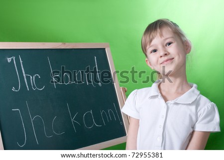 The girl near a board on which it is written in German, I can.