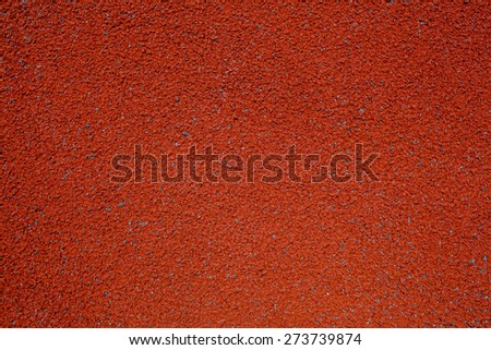 Background texture of brown crumb rubber used for athletic tracks and children playgrounds