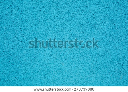 Background texture of blue crumb rubber used for athletic tracks and children playgrounds