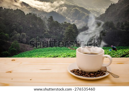 Morning cup of coffee with mountain background at sunrise .vintage color tone