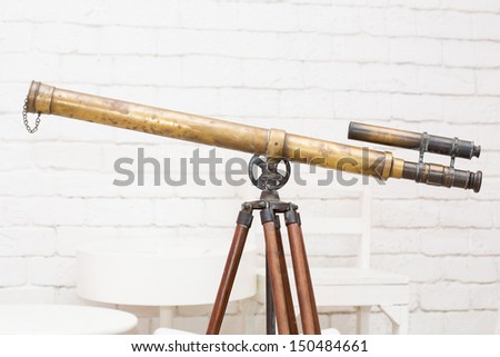 Antique brass telescope on white background