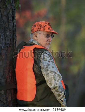 Deer Hunter Leaning Against Tree