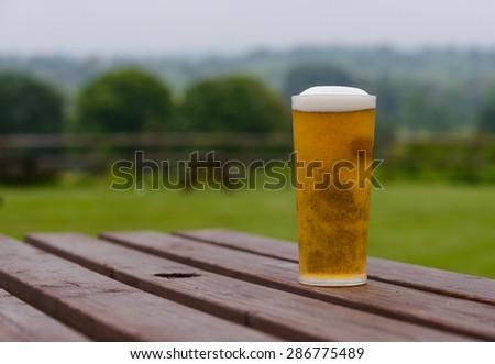pint of lager beer on country pub beer garden table