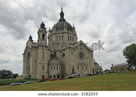a picture of a majestic cathedral upon a hill in the city of St. Paul,  reaching into clouds