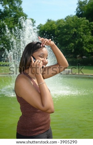 A picture of a beautiful woman talking on a cellphone