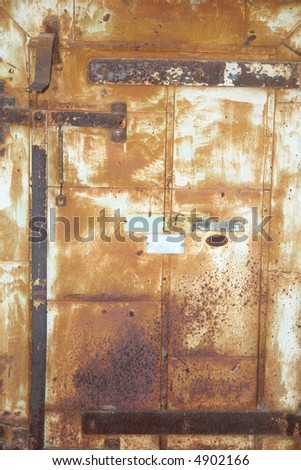 A picture of an old rusty iron door