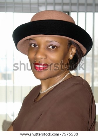 A picture of a beautiful woman with hat and wearing red lip stick