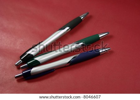 A picture of three ballpoint pens ready for writing