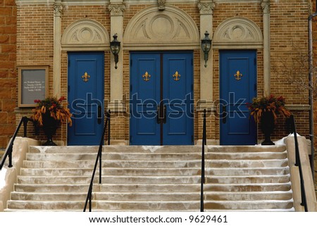 A picture of entrance of  three fancy blue doors