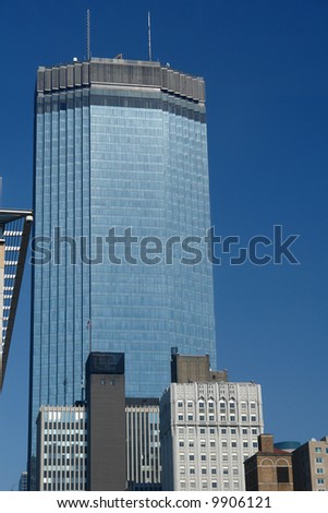 A picture of a strong tower standing high above other buildings