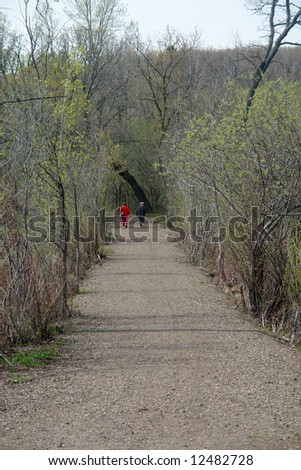 A picture of people walking through woods