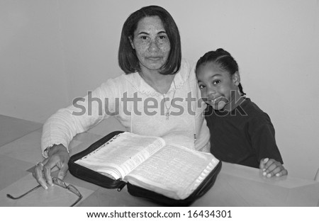 A picture of an African American mother and child studying  book