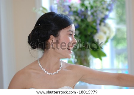 Young Asian Bride sharing a smile during the first dance