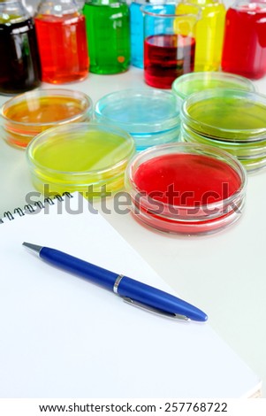 Colorful fluid in petridish for laboratory use on table in laboratory