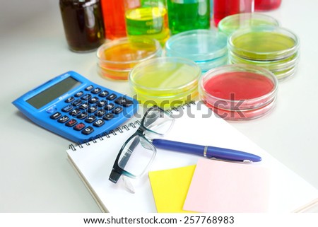 Colorful fluid in petridish for laboratory use on table in laboratory