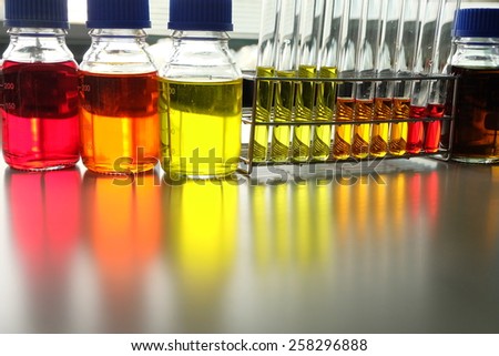 Colorful fluid in bottle and test tube for laboratory use on table laboratory