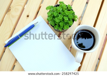 Blank paper and office tools on the wood table with black coffee