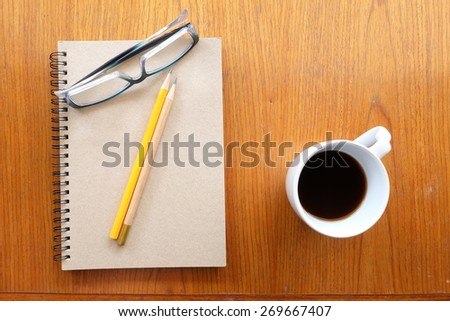 note book and office tool on wooden background